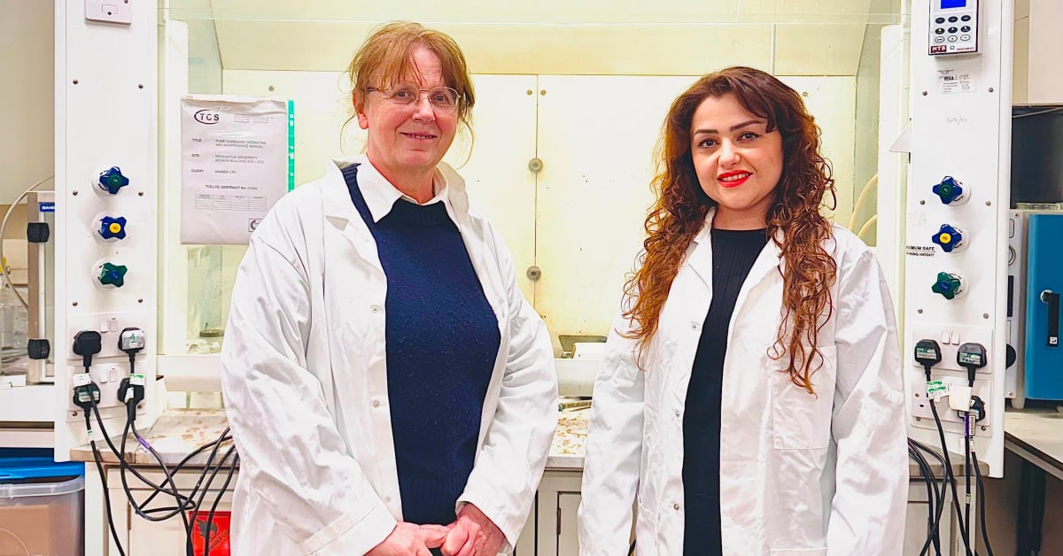 Scientists Lidija Siller and Kaniaw Marof stand side by side in a laboratory setting.