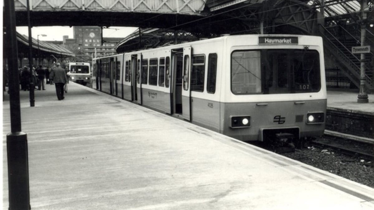 Image shows a historical photo of a Metro train pulling into Tynemouth station