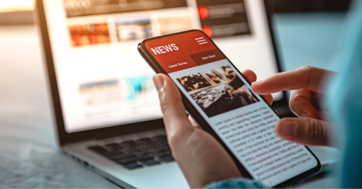 Image of someone looking at news on smartphone